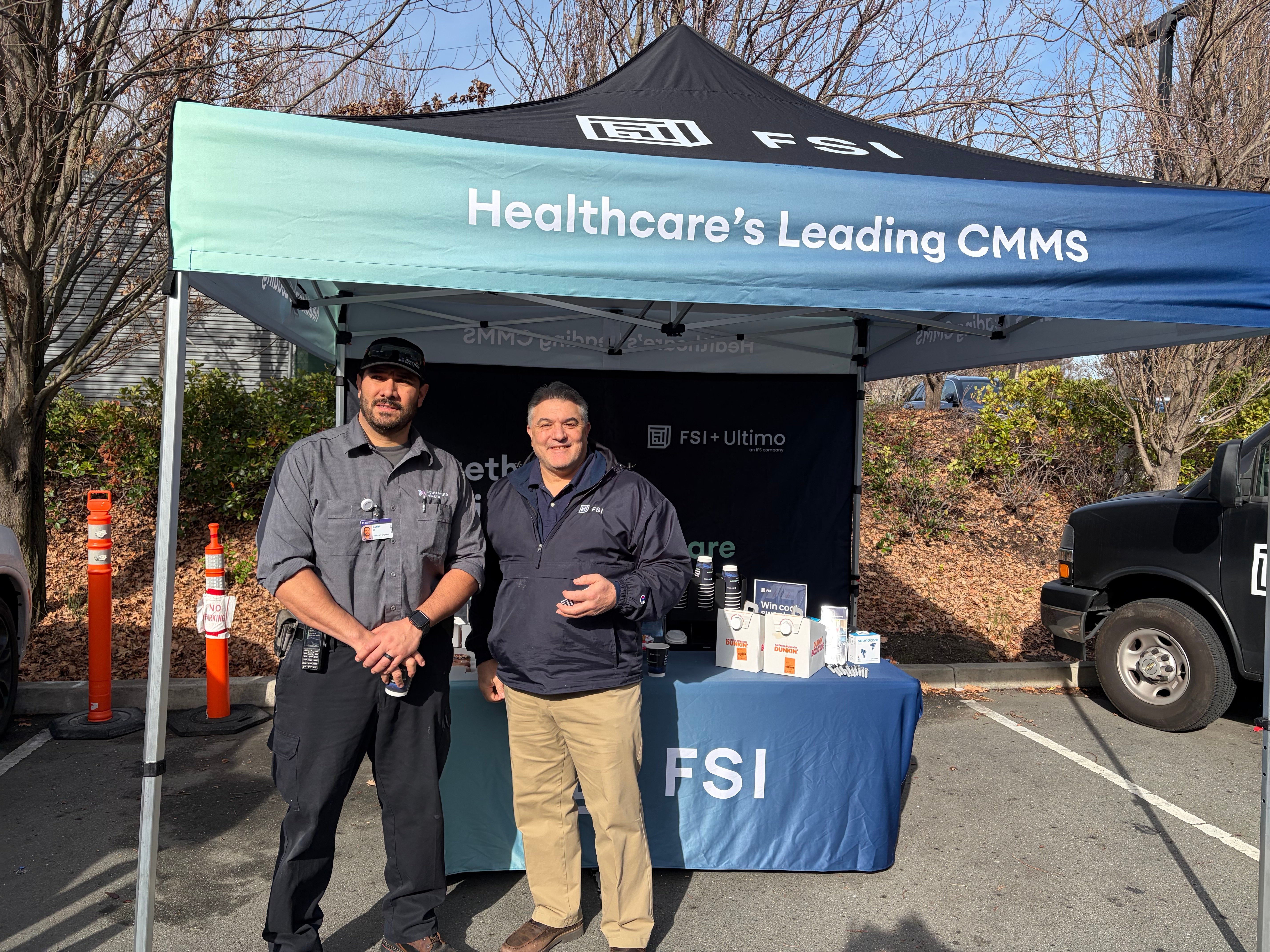 FSI staff and attendee by tent